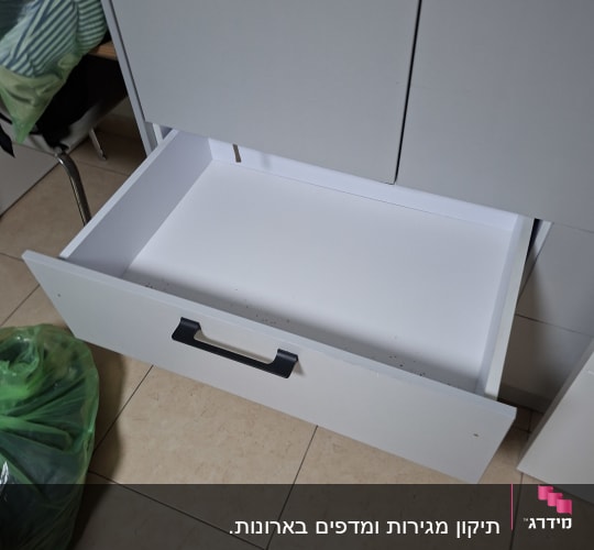 מגירה פתוחה ליד ארון במטבח
